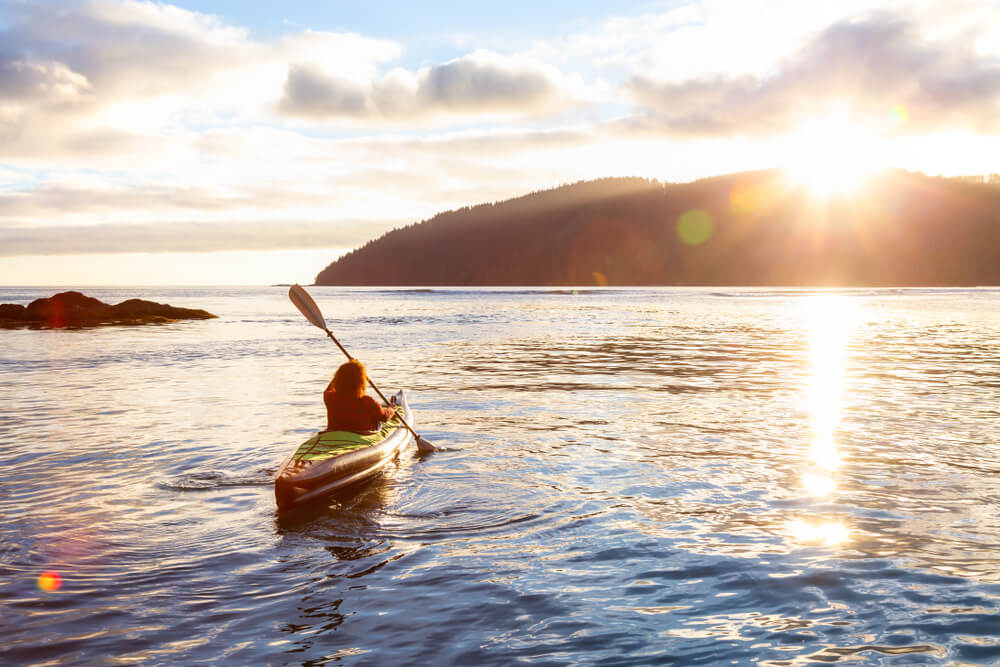 A kayaker paddles into the distance while enjoying one of the San Juan Islands' many activities.