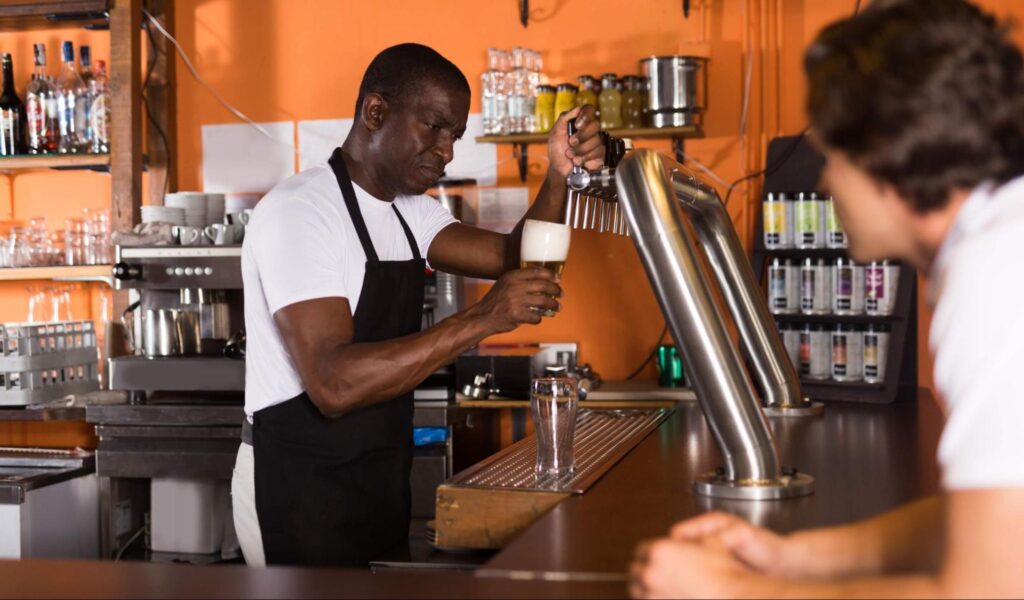 A bartender serves up a lager at a San Juan Island brewery.