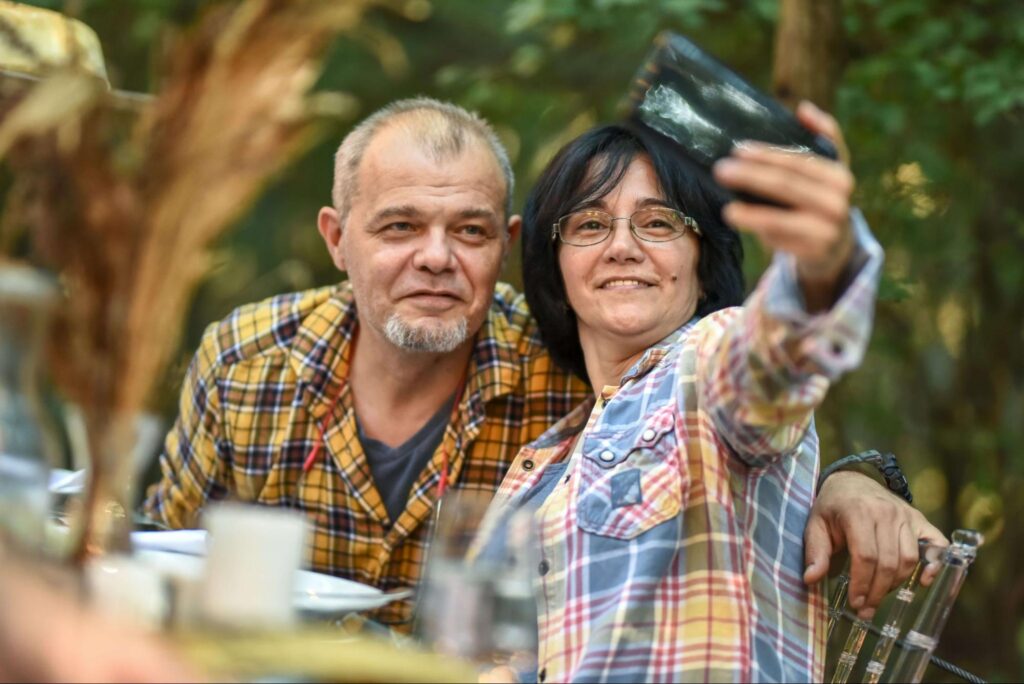 A couple of tourists take a selfie while enjoying one of the many excellent San Juan Island Restaurants near their vacation rental.