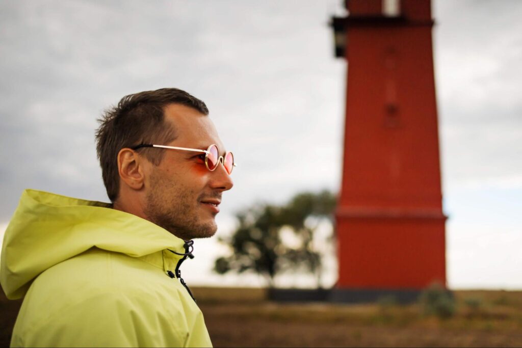 A man wearing sunglasses smiles as he prepares to check out another one of Washington's lighthouses amid the San Juan Islands.