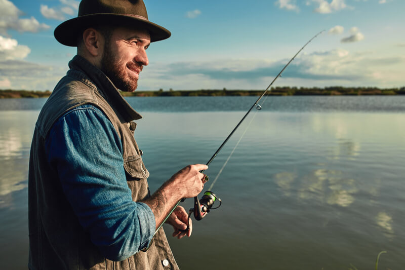 An angler looks off in the distance while fishing in the San Juan Islands.