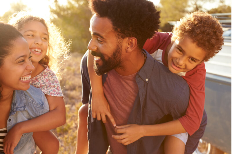 A family with kids smiles while contemplating things to do in the San Juan Islands.