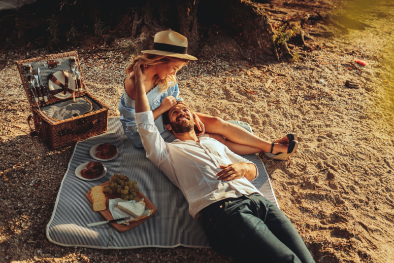 A romantic couple enjoys a lovely picnic in the park on San Juan Island.