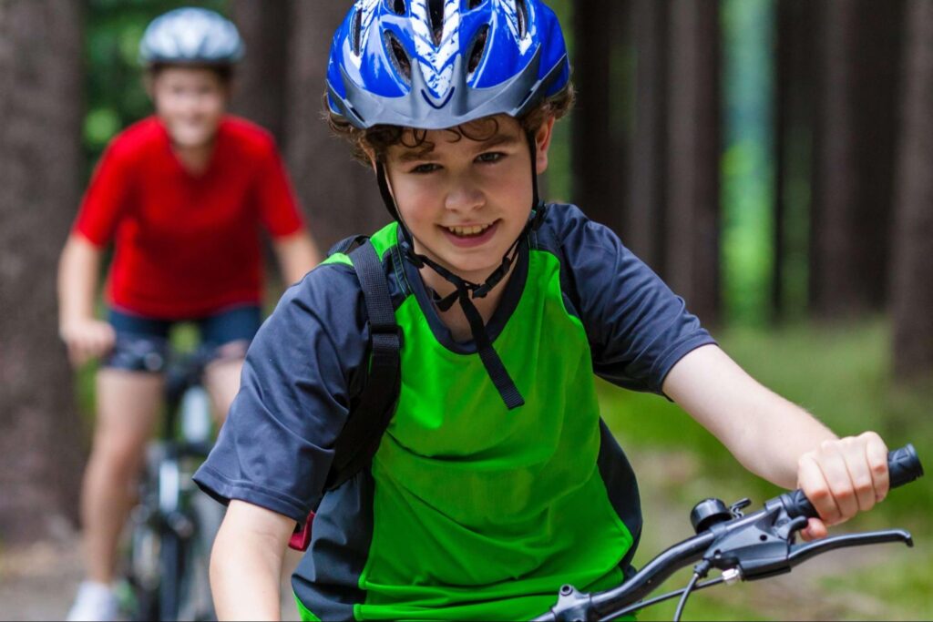 A young boy and his older brother hit the trails on a San Juan Islands bike tour.