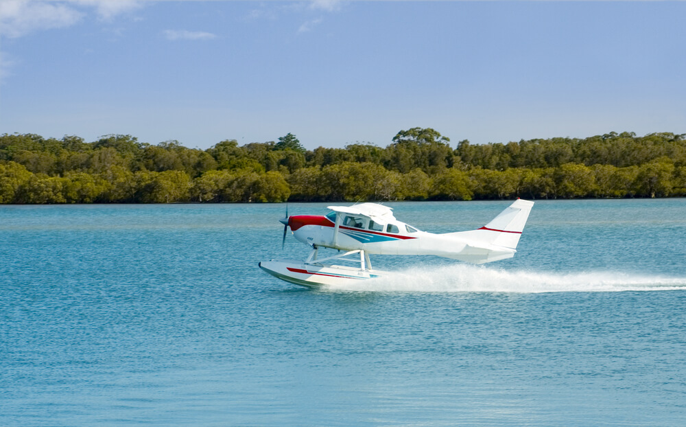 A white seaplane lands after a scenic tour of the San Juan Islands.